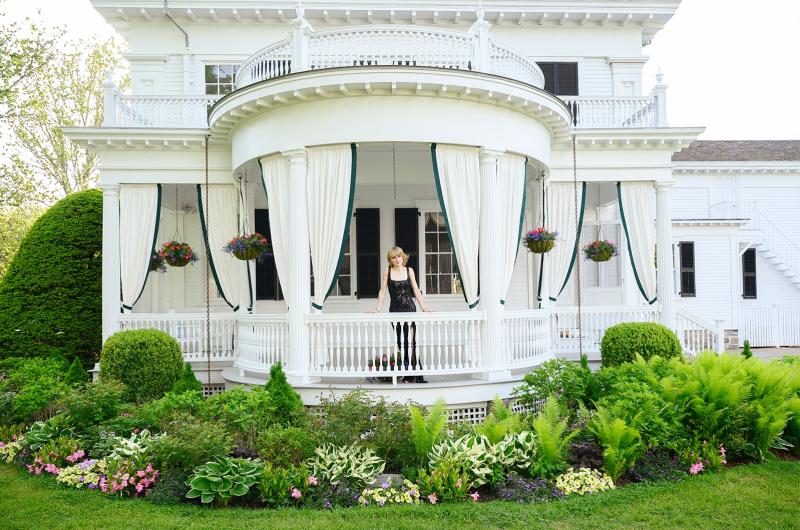 Lillie Cabral models on the porch of the Fisher house.