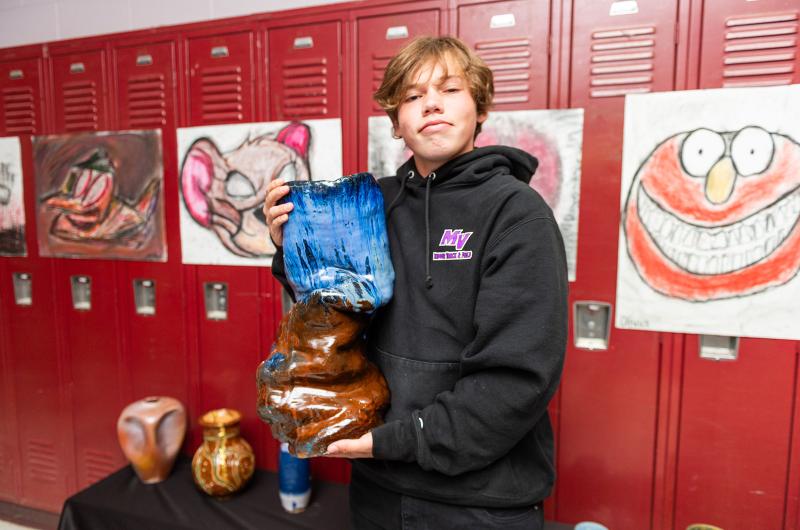 Lorenzo Diaz with his ceramic sculpture.