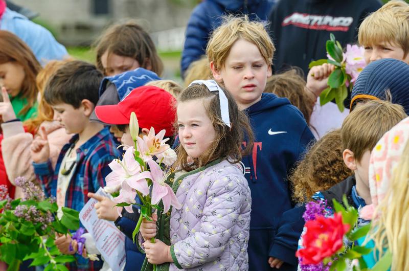 Chilmark school students hold flowers for memorial day.