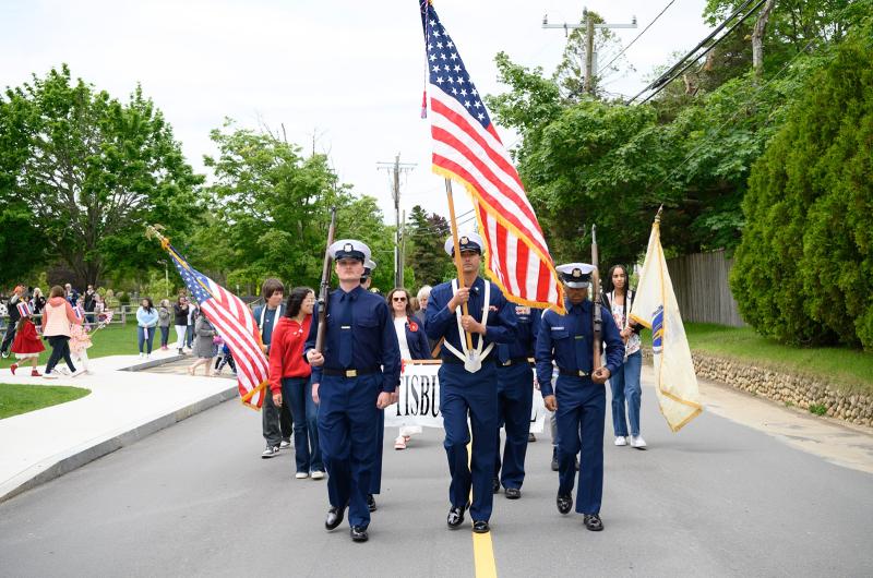 An honor guard leads the way.