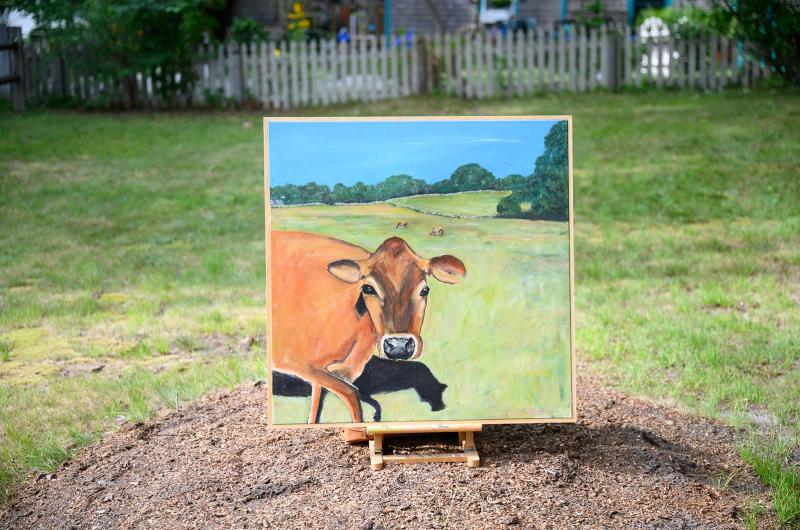 Cow painting by Elizabeth Greene on display in the pasture.