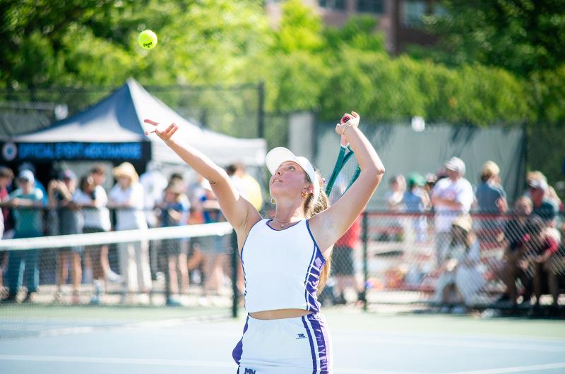 Tessa Shultz tosses up a serve.