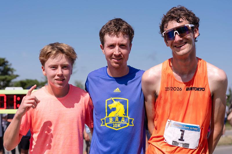 Sam Fetters (right) with a time of 28:01.3, to his left are the second and third place finishers Ryan Sawyer and Benjamin Fuller.