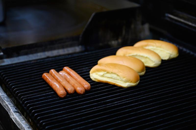 Dogs and buns on the grill.