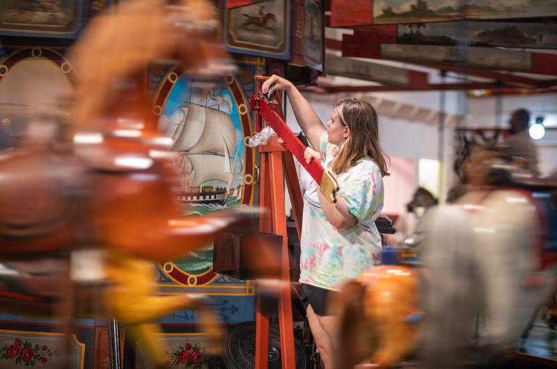 An employee loads rings on the inside track.