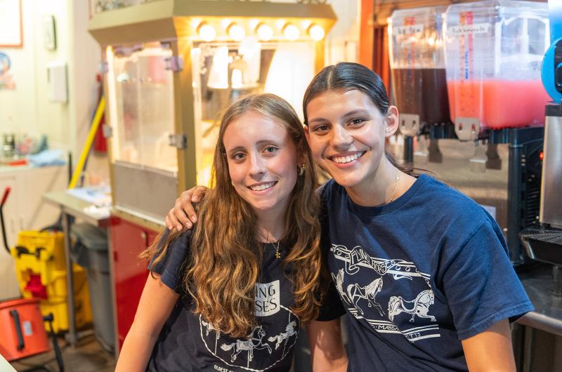 Ondine Hitchen and Sofia Fisher enjoying a shift together behind the ticket counter.